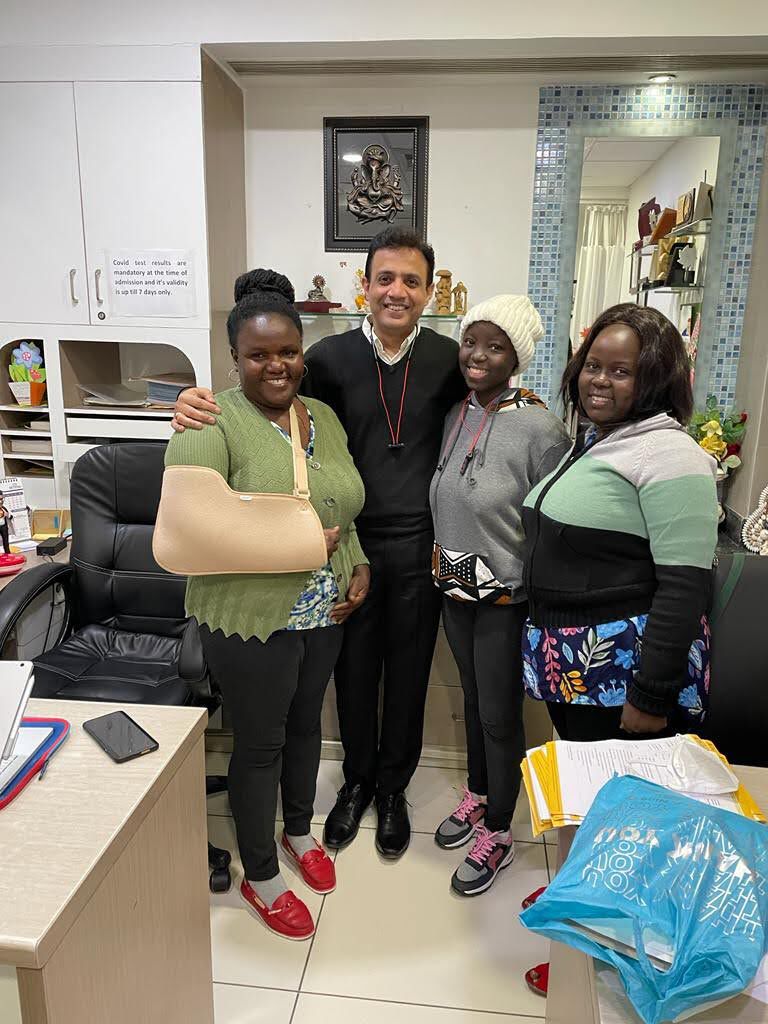 Desire and family members with her doctor in India